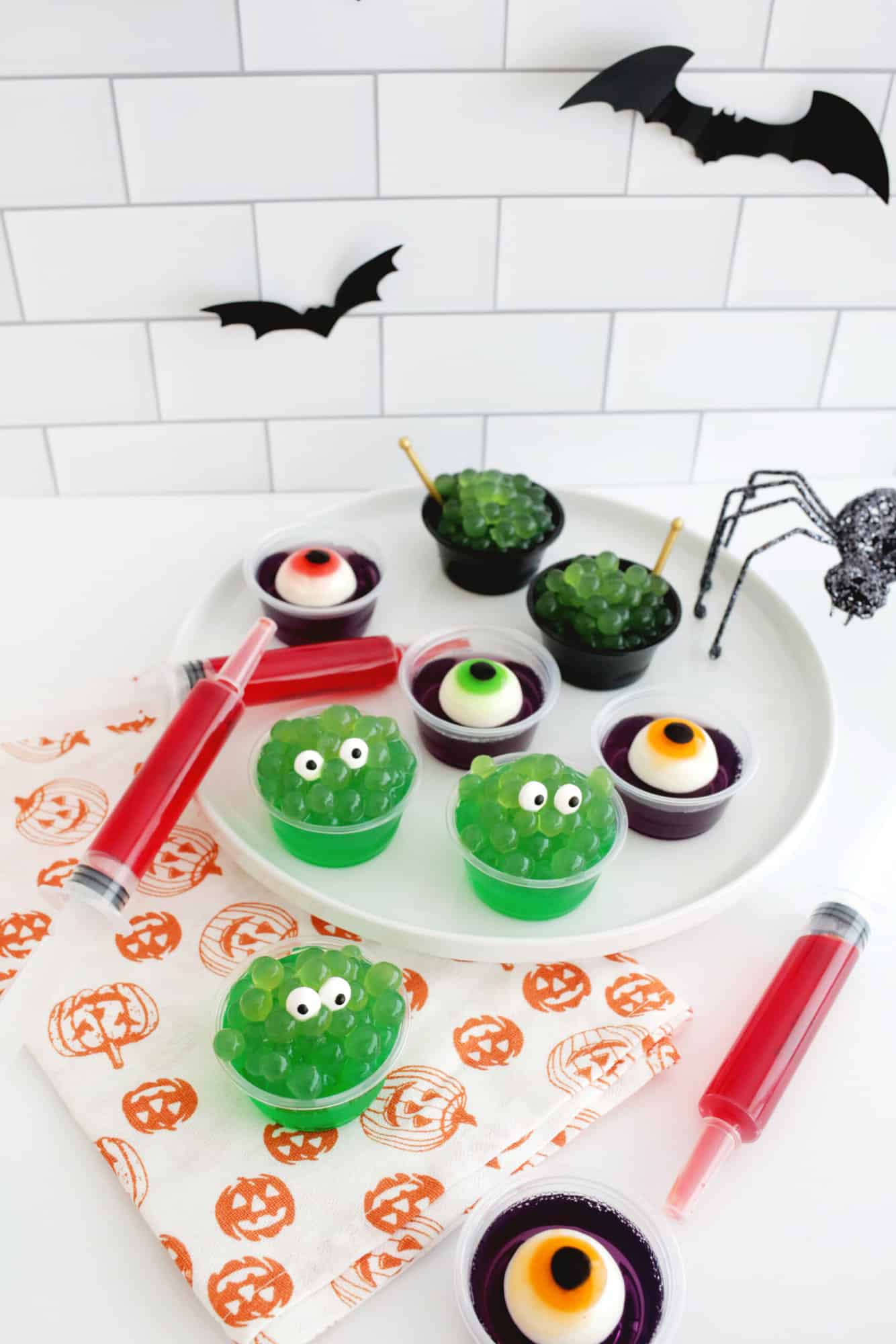 easy halloween jello shots that look like monsters, eyeballs, syringes, and witch's cauldrons