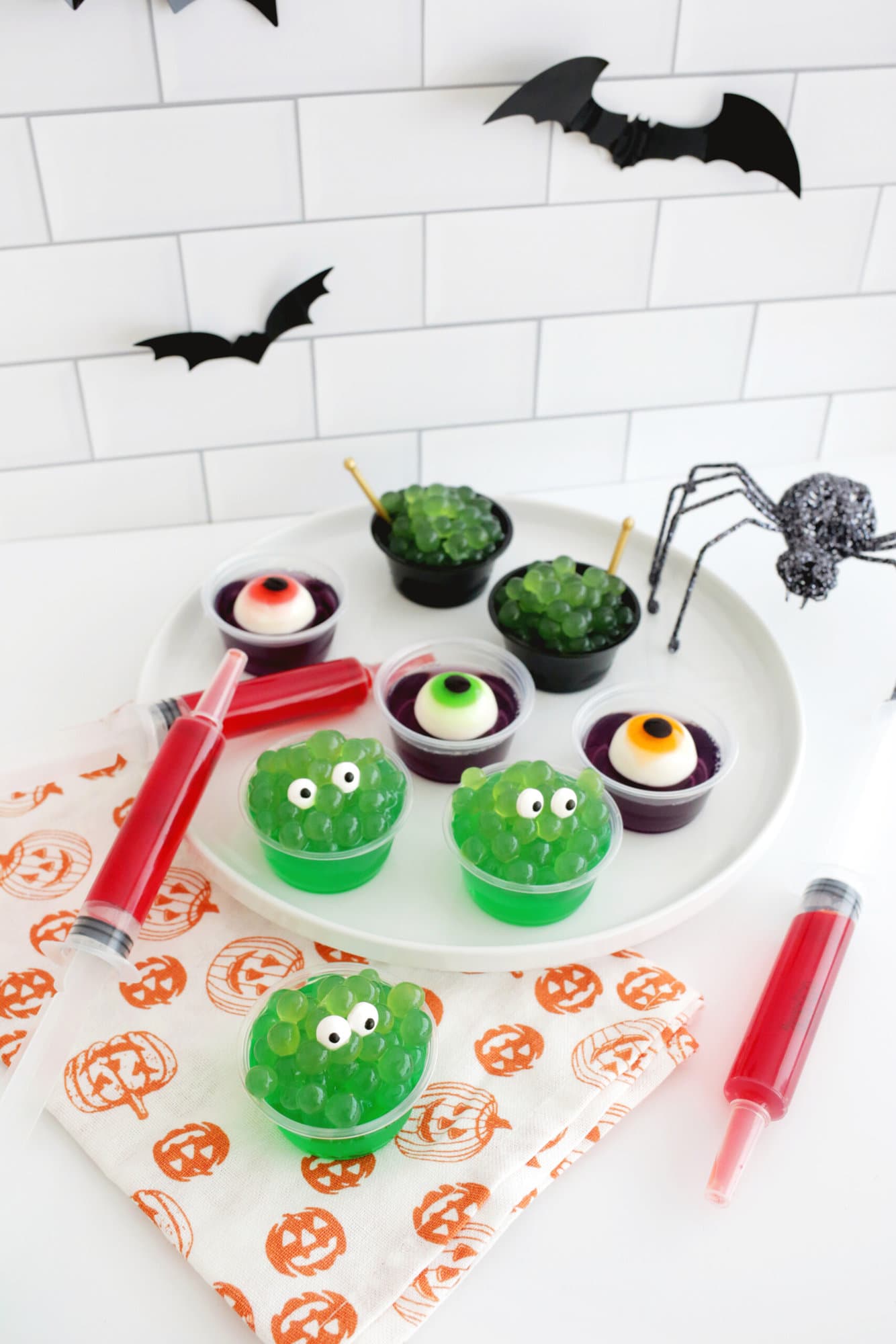 easy halloween jello shots that look like monsters, eyeballs, syringes, and witch's cauldrons