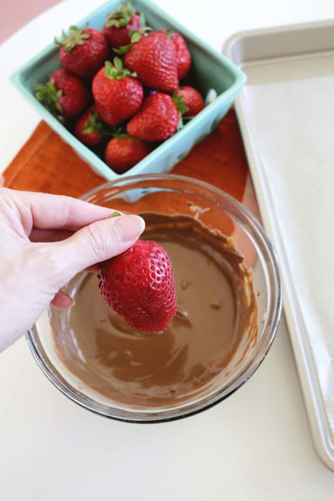Dipping strawberries for chocolate covered strawberries