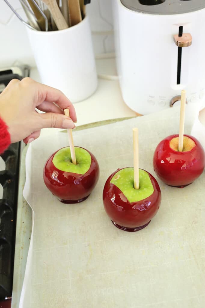 setting candy apples on parchment paper