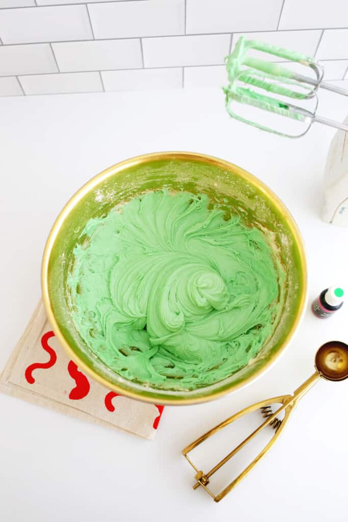 mixing green batter for grinch cookies