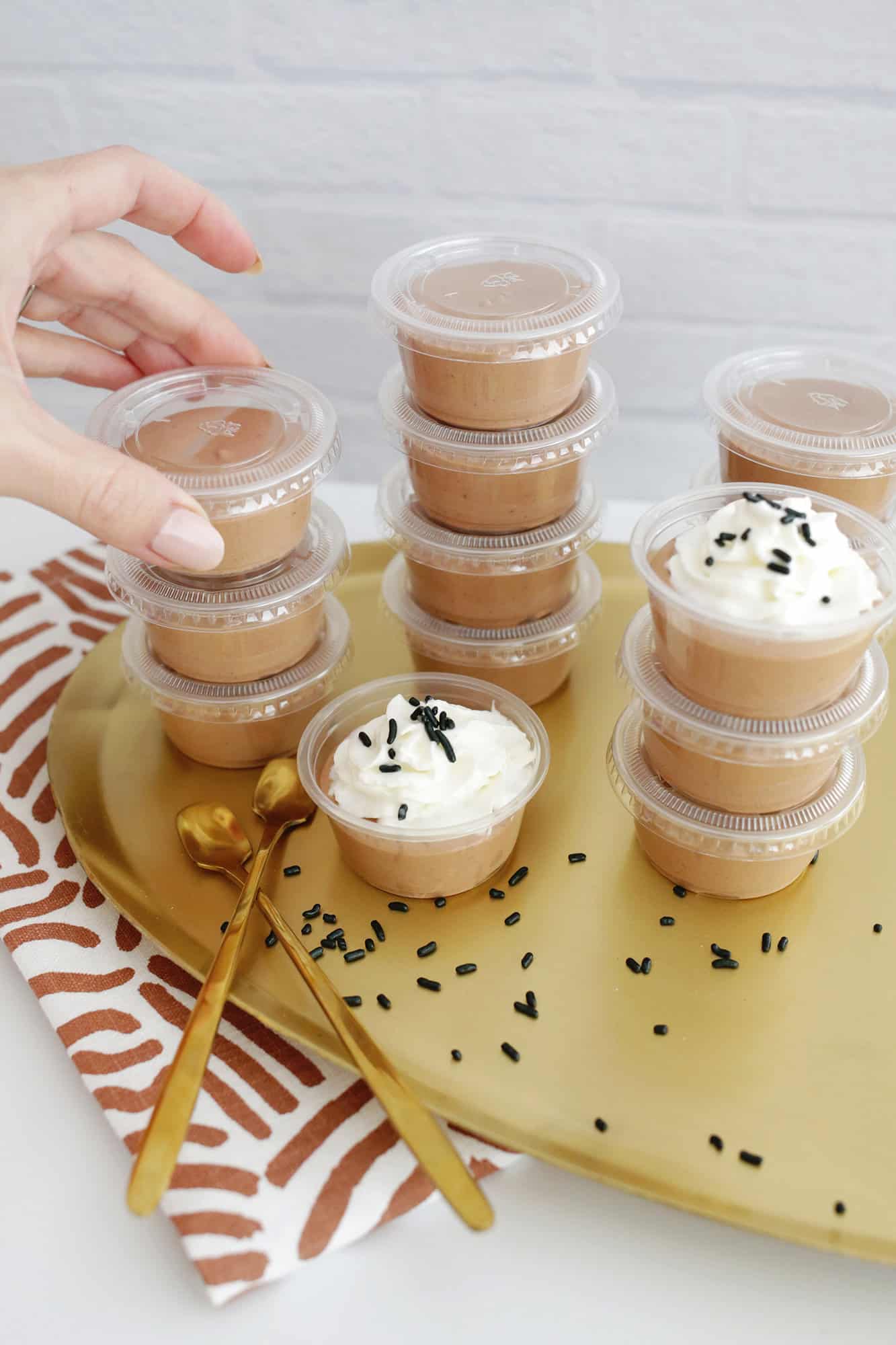 chocolate pudding shots with whipped cream and sprinkles