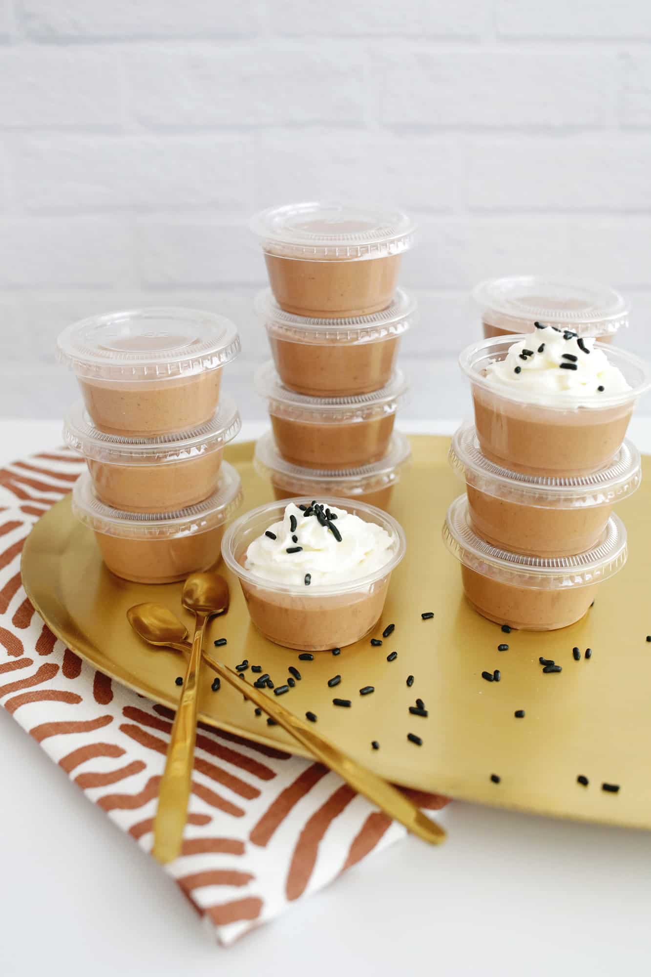 chocolate pudding shots with whipped cream and sprinkles