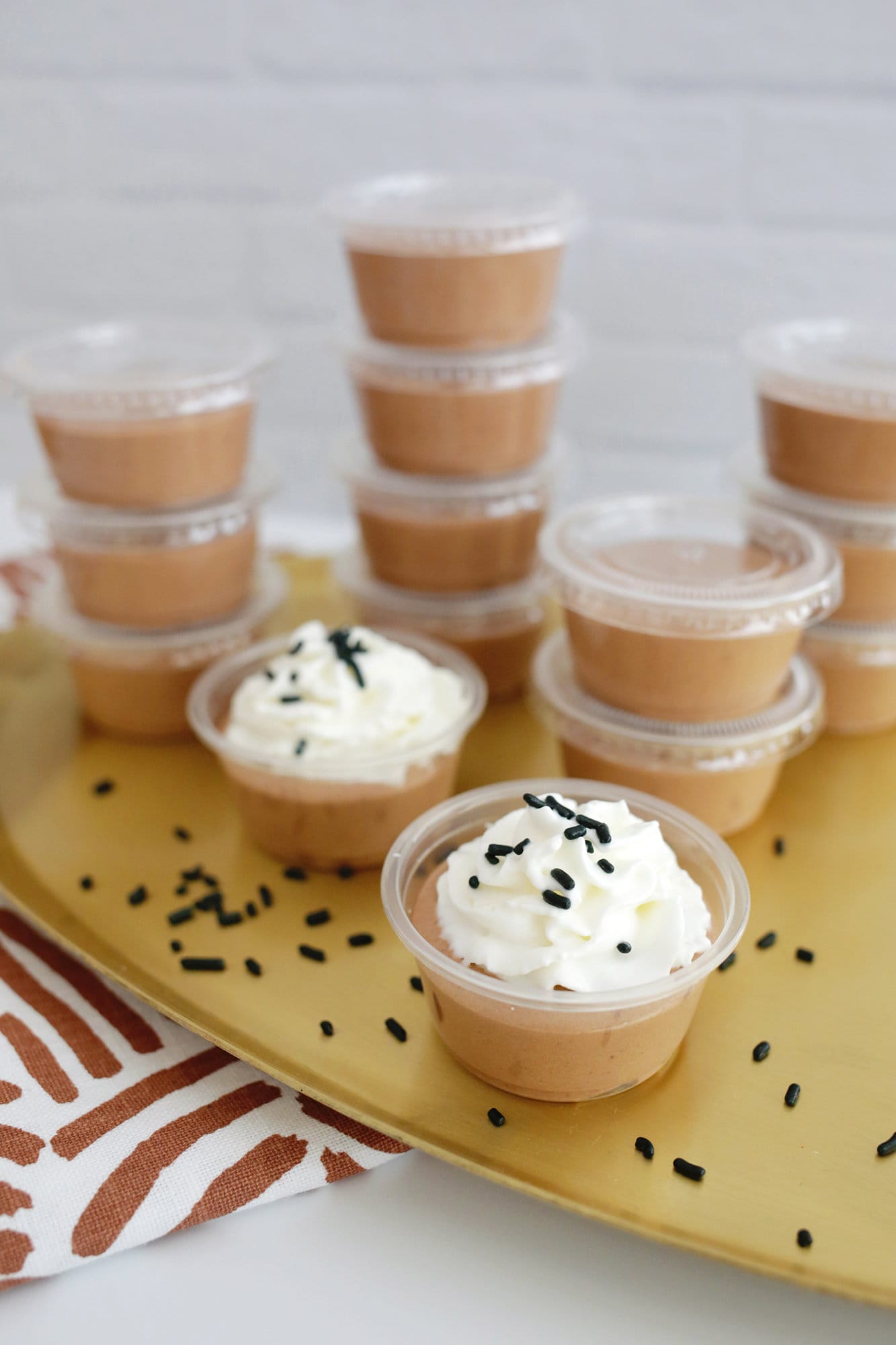 chocolate pudding shot with whipped cream and sprinkles