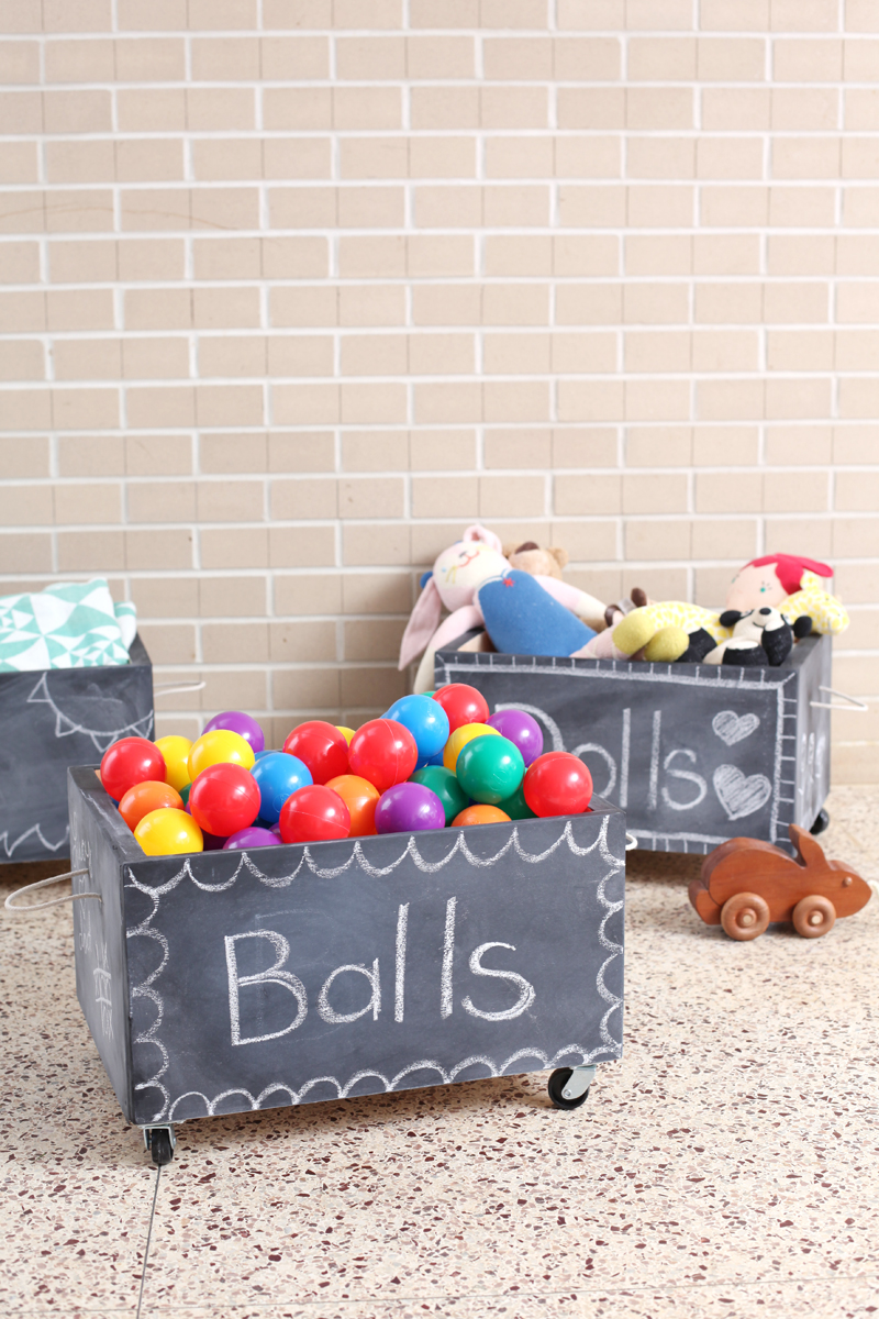 Make your own rolling chalkboard toy box using a crate as a base. Click through for instructions!
