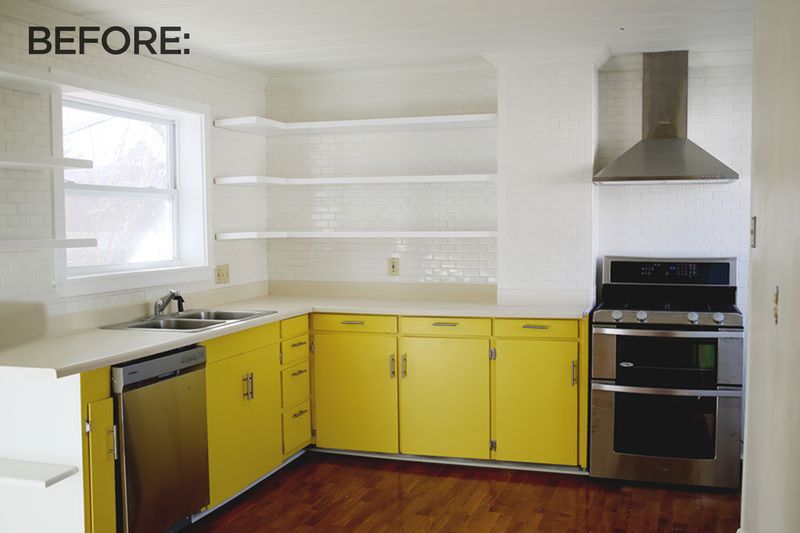 a before picture of a kitchen with yellow cabinets, white brick walls, and a tan countertop