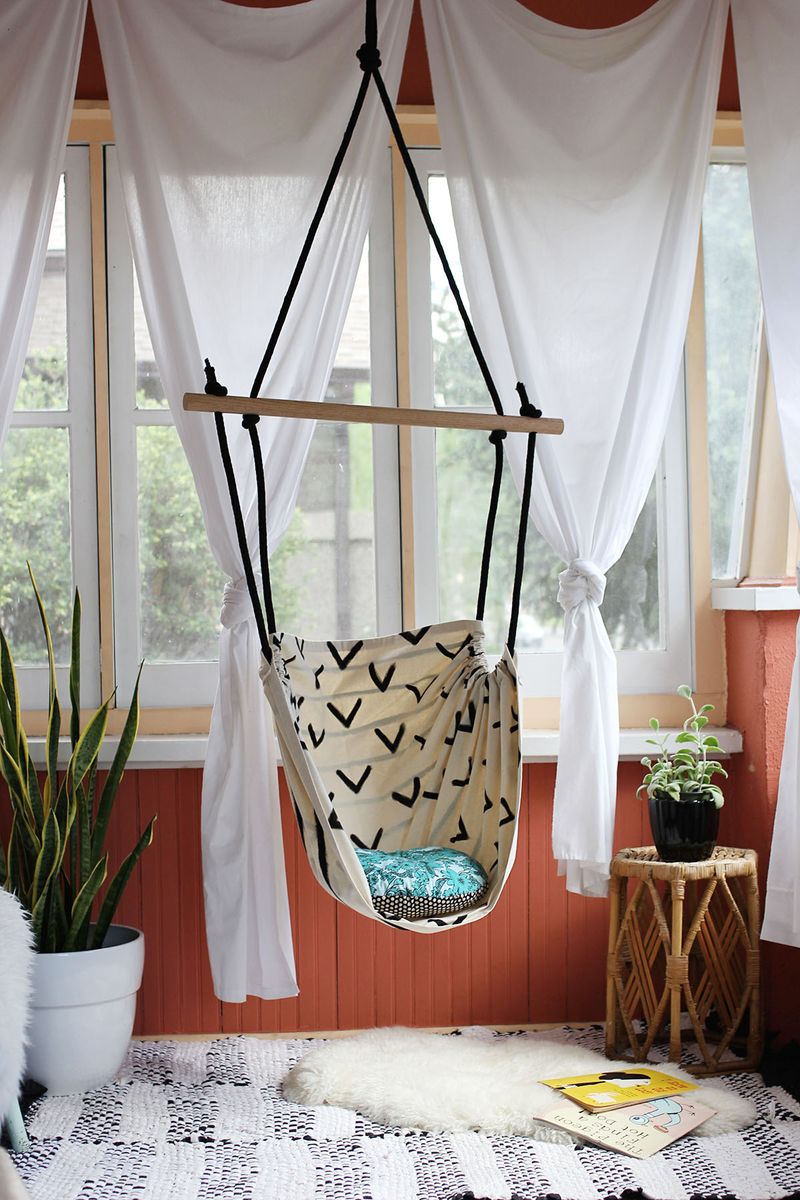 Indoor Hammock Chair hanging from ceiling in front of window