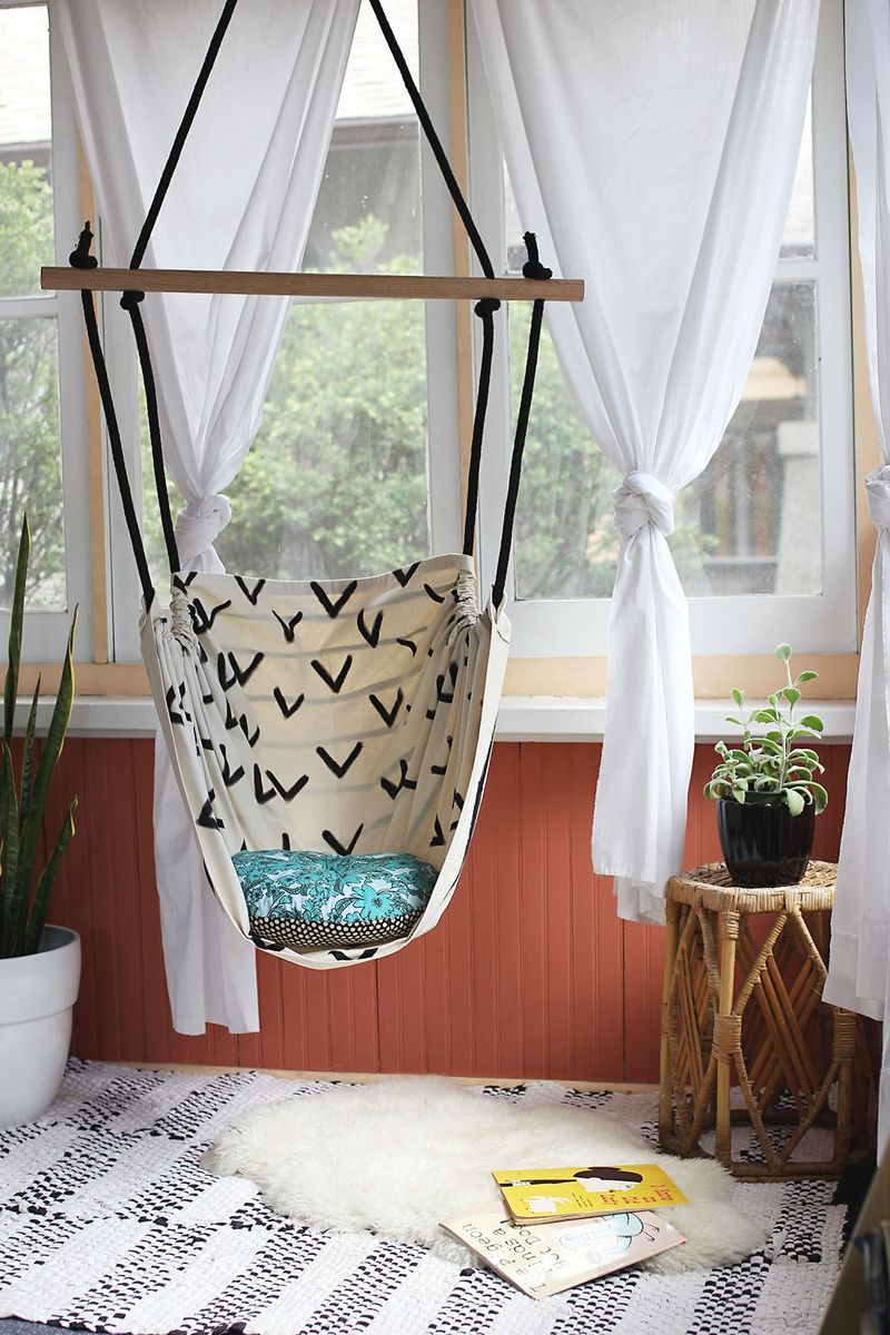 an empty hammock hanging in front of a window