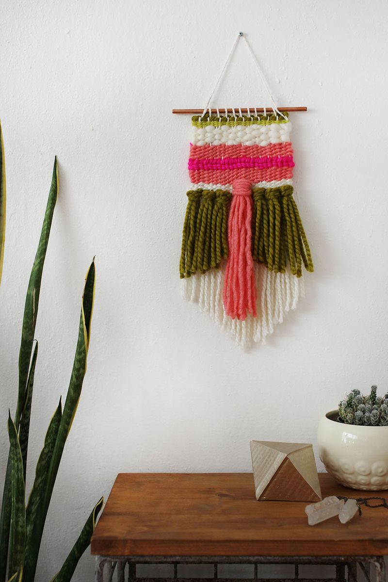weaving project hanging on a white wall
