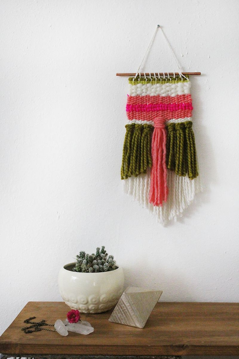 weaving project hung on white wall