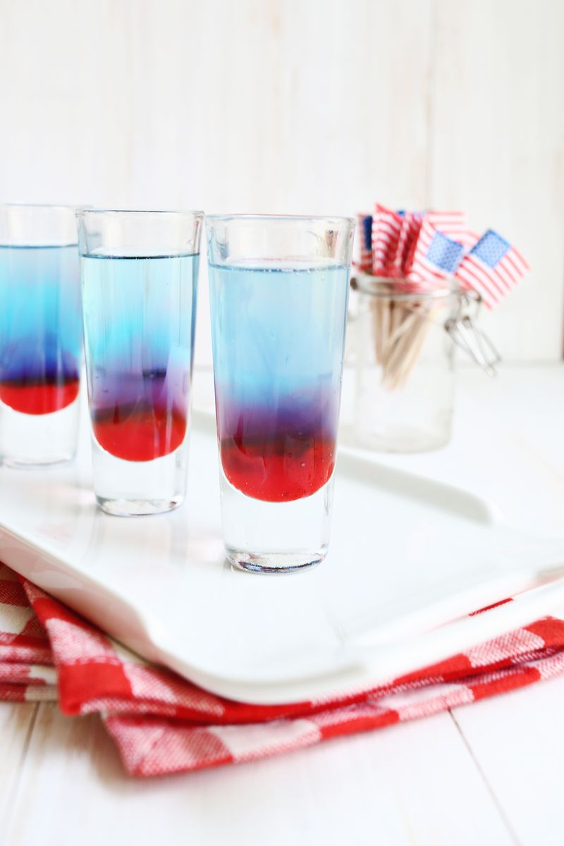 close up of one of the glasses of bomb pop shots on a white platter