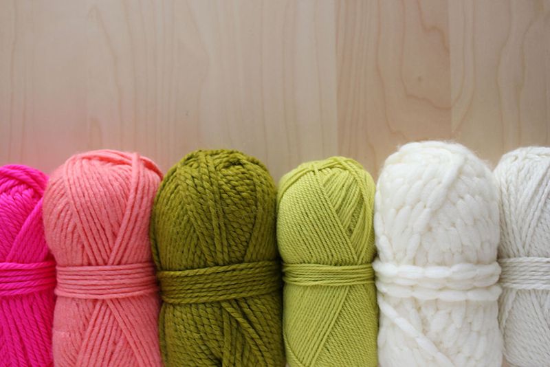 hot pink, light pink, green, neon green, and white yarn with white string