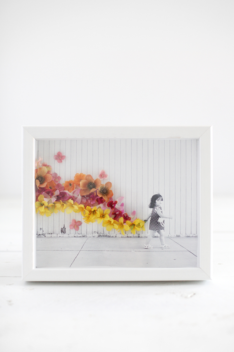 Turn a simple photo into a work of art with artificial flowers and hot glue.