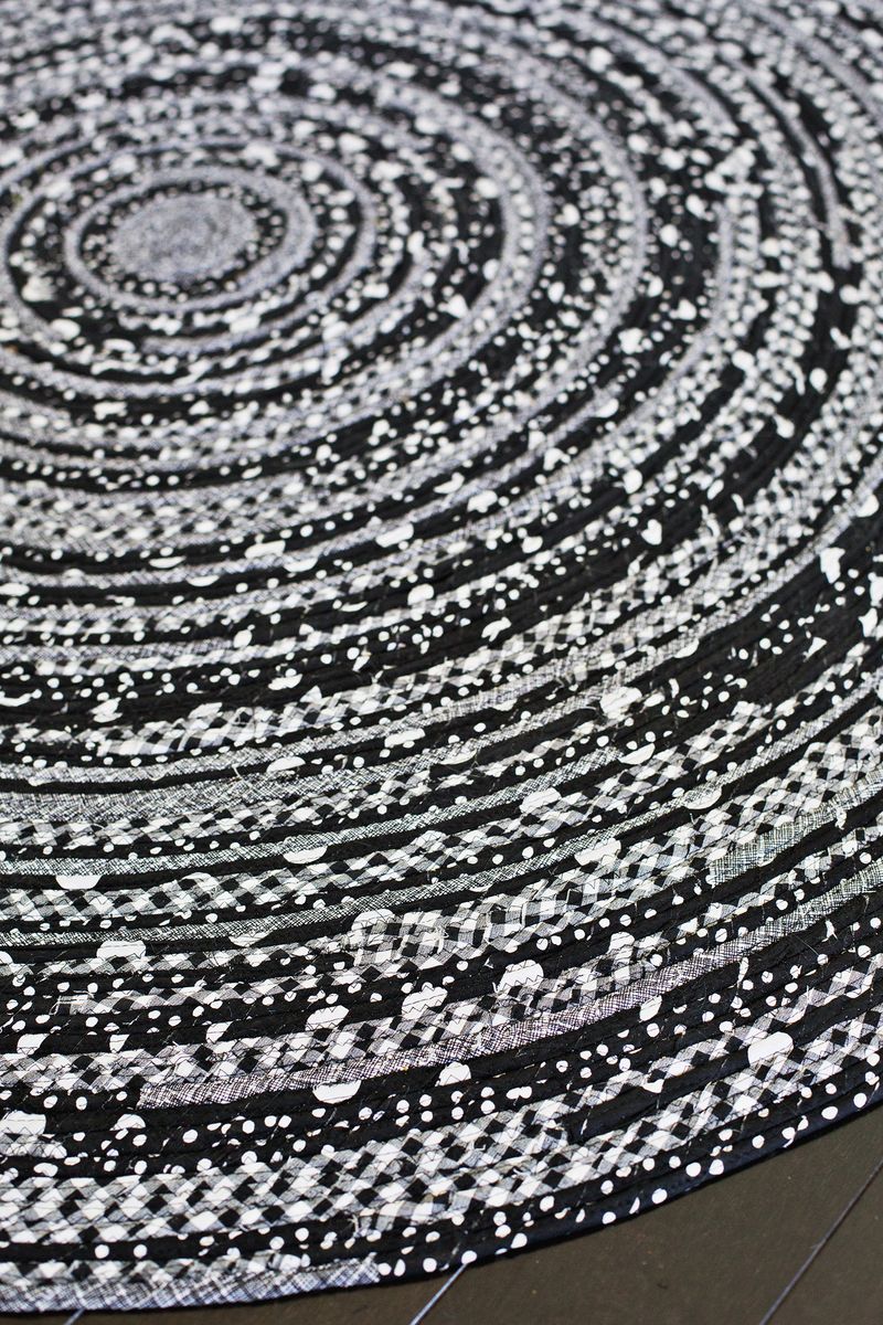 a close up of the black and gray circle rope rug 