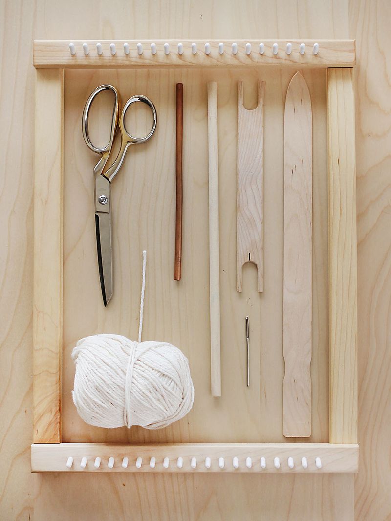 scissors, white string, shuttle, shed stick inside a loom