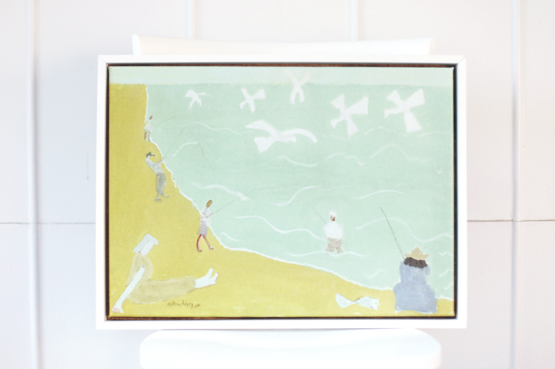 a finished wood frame around a painting of people fishing in a lake