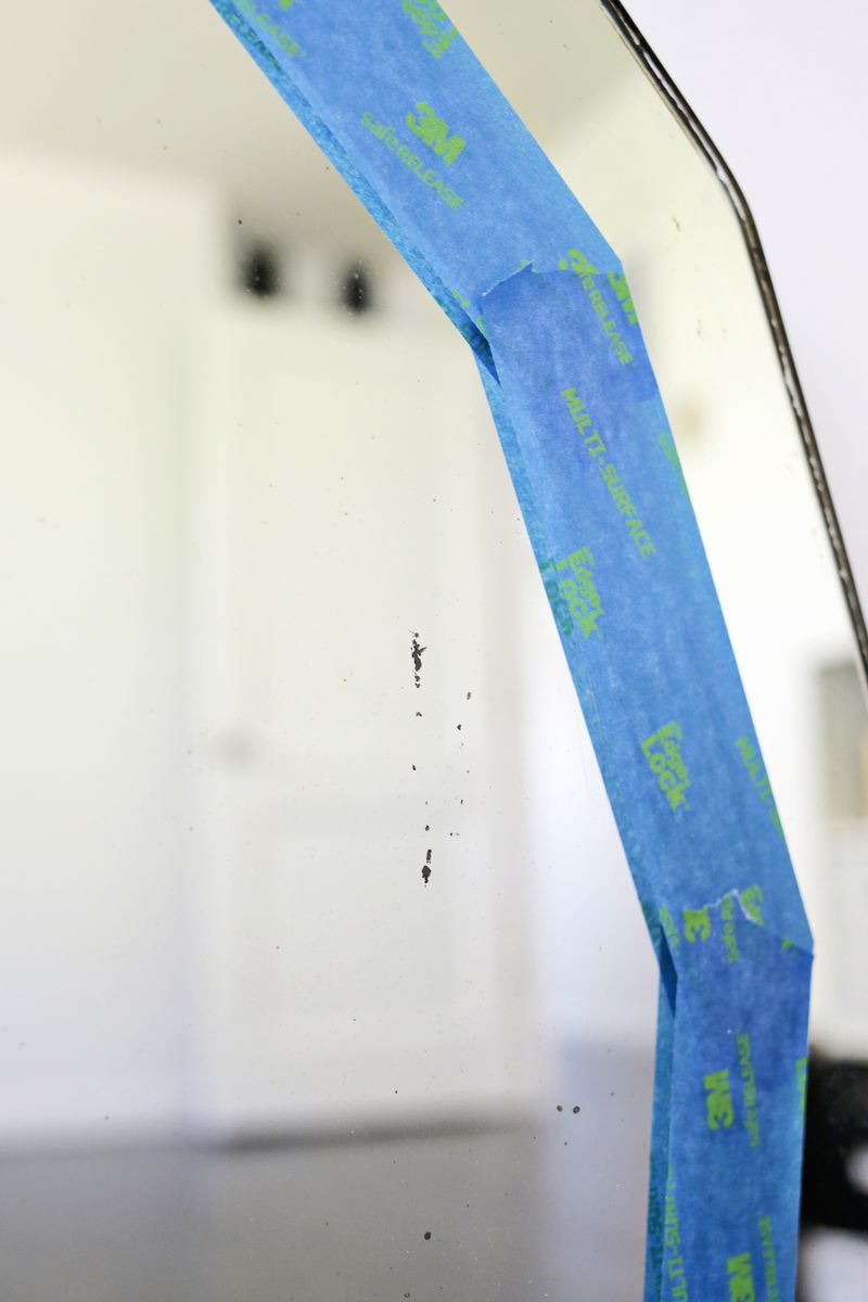 blue painter's tape outlined on a mirror