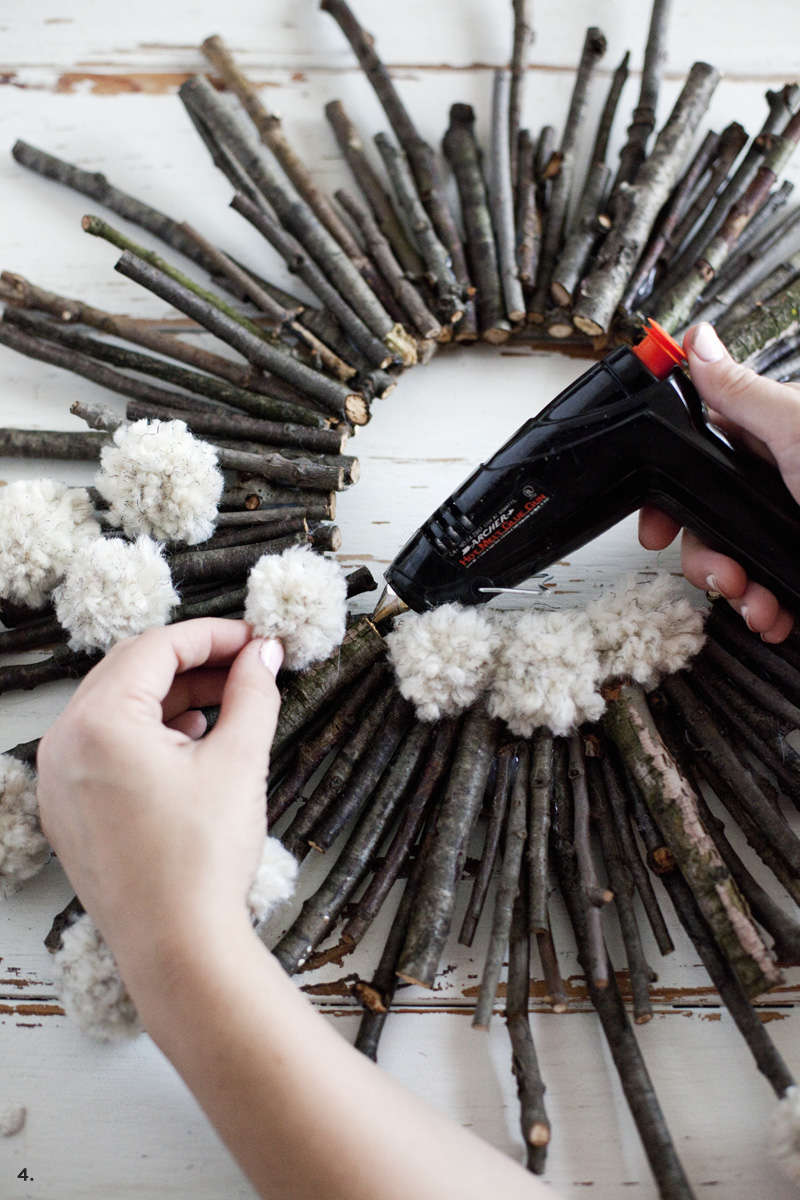 Make a twig and pom pom starburst wreath— It's practically free!