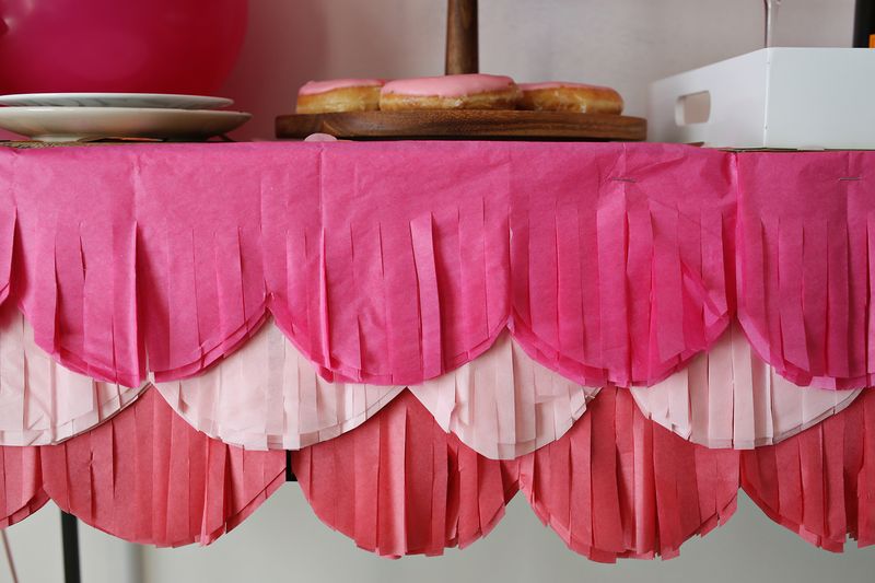 the finished fancy scalloped tablecloth on the table with cookies on top