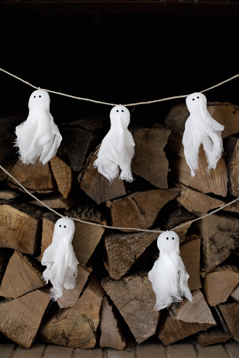 ghost garland in front of a pile of wood