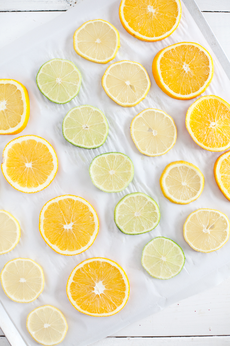 slices of oranges, lemons, and limes on a paper towel
