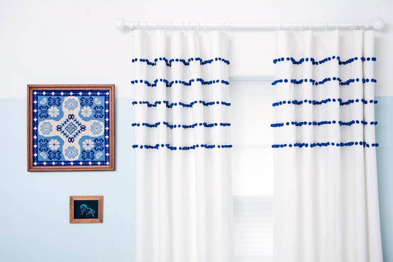 Make a whimsical pair of pom pom striped curtains for surprisingly little money.