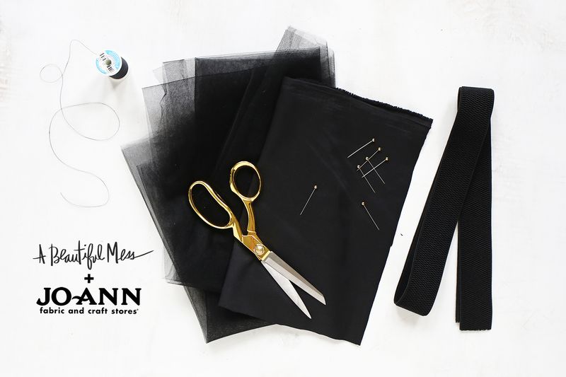 black tulle, gold scissors, black thread, straight pins, and black elastic