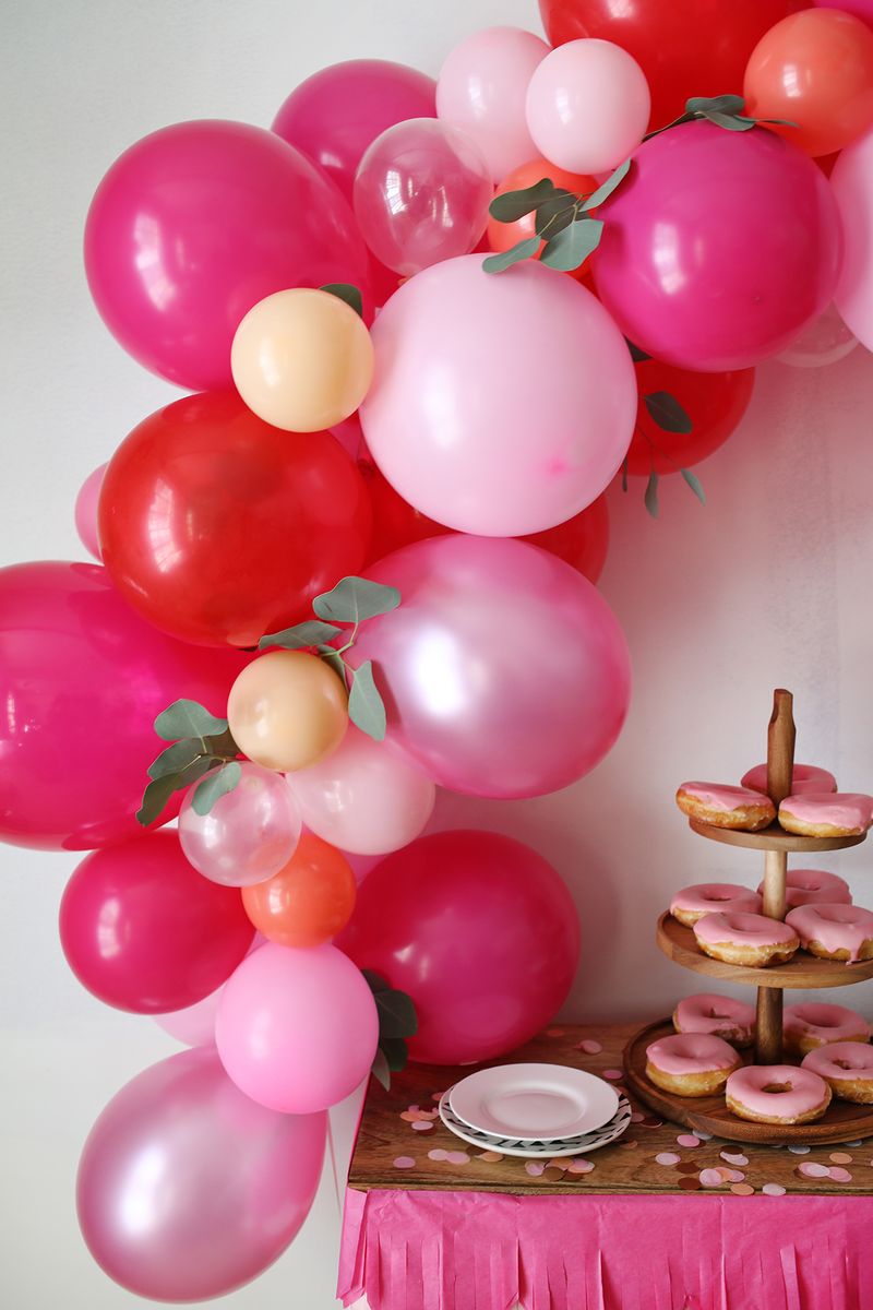 a close up of the balloon arch over the table